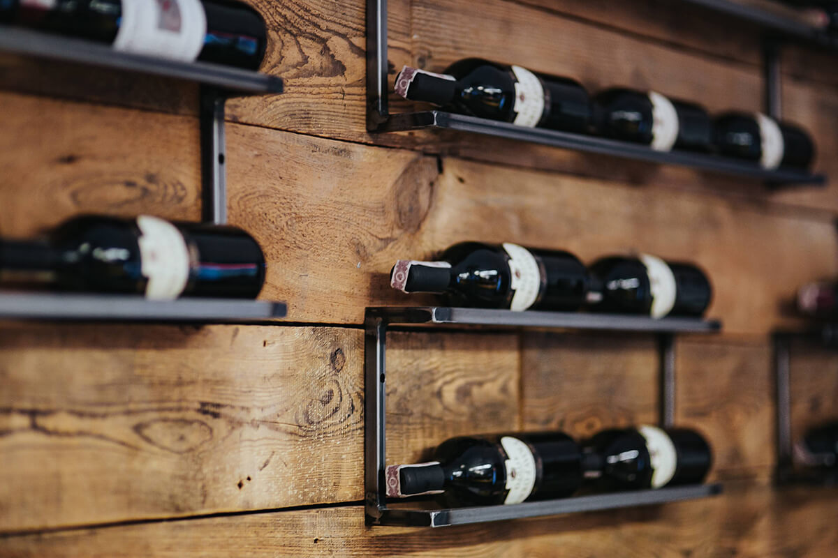 red wine bottles stacked horizontally on racks