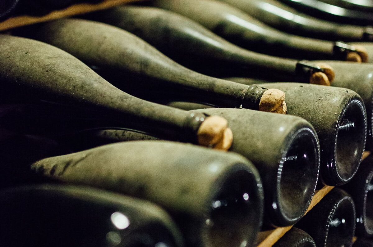 stacked bottles of cava aging on the lees