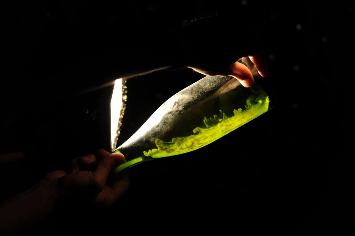 stirring of lees in a sparkling wine bottle