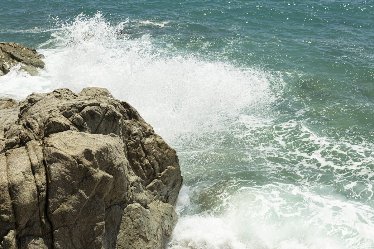 sea waves splashing on coastal rocks in emporda region